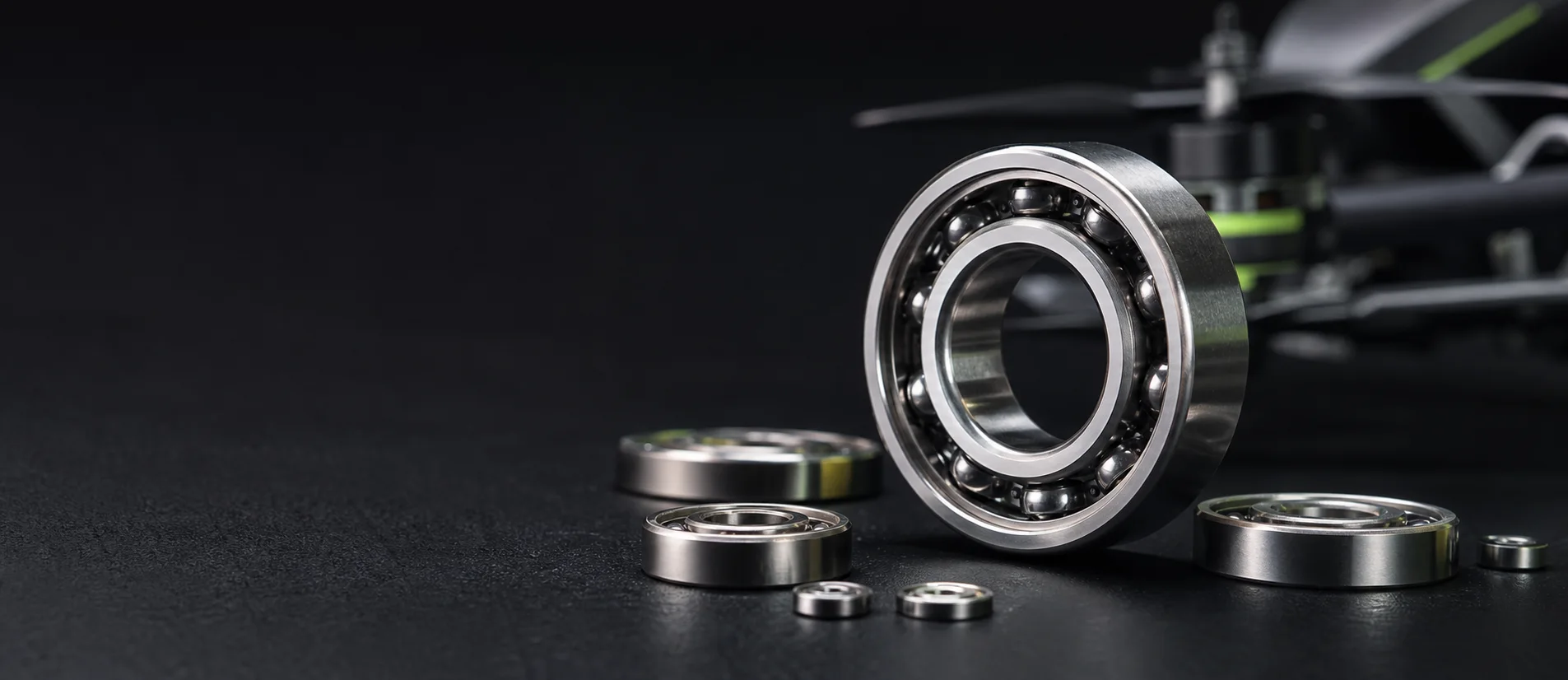 Stainless steel ball bearings in front of a precision drone rotor assembly.